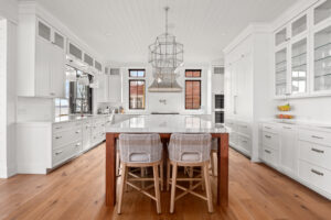 Beautiful custom kitchen cabinets, white cabinets with white countertop and wooden accents, bright and open, Brookwood Cabinet Company
