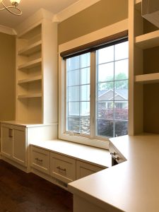 Custom built-in window seat with drawers, shelving, and desk nook in a Brookwood home in Fort Wayne, Indiana