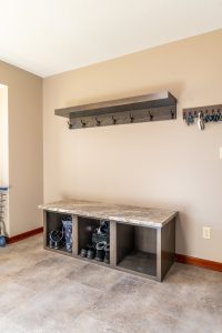 Custom mudroom with built-in bench, cubbies, and wall hooks for coats and bags in a Brookwood home in Fort Wayne, Indiana
