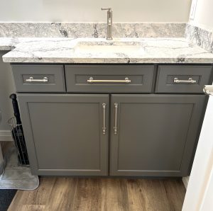 Custom bathroom vanity with gray cabinetry and granite countertop in a Brookwood home in Fort Wayne, Indiana
