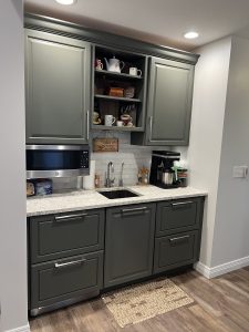 Custom residential bar area with cabinetry and sink in a Brookwood home in Fort Wayne, Indiana