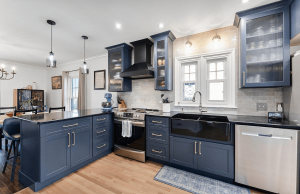 Custom kitchen with painted navy wood cabinetry, granite countertops, stainless steel appliances, in a Brookwood home in Fort Wayne, Indiana